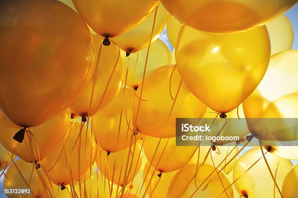 Bright Yellow Balloons Backlit In Sky Background Stock Photo - Download Image Now - Yellow, Balloon, Party - Social Event