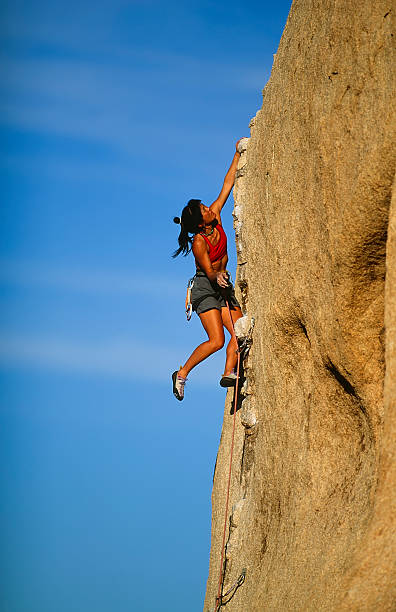 Young climber rock climbing