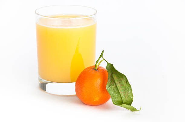 Glass of  juice and an orange stock photo