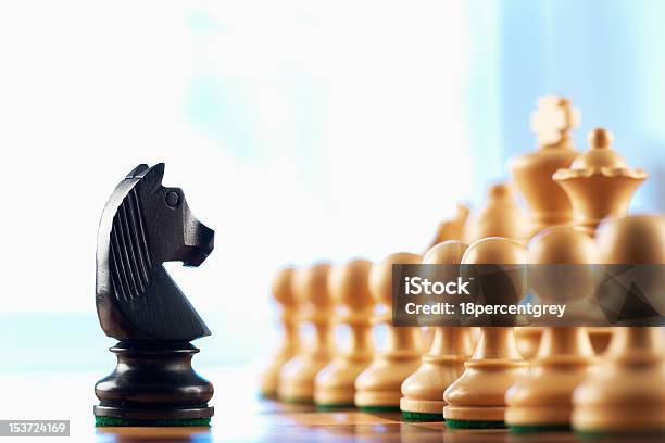 Chess Black Knight Challenges White Pawns Stock Photo - Download Image Now - Black Color, Blue, Challenge