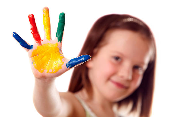 istock A small child with paint on her hand 153727628