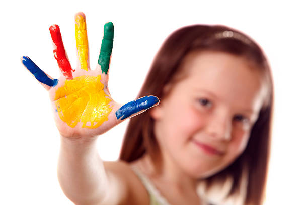 A small child with paint on her hand stock photo