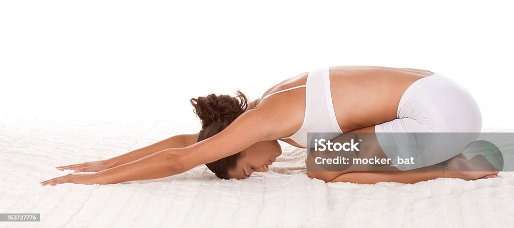 yoga pose - female in sport clothes performing exercise "yoga ""Child's Pose"" - female in sport clothes performing exercise    " 20-29 Years Stock Photo