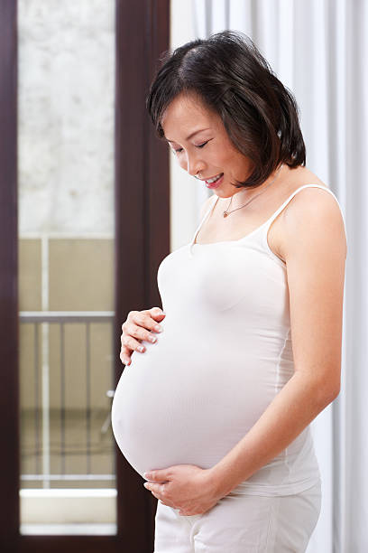 istock Pregnant lady caress her stomach 153728246