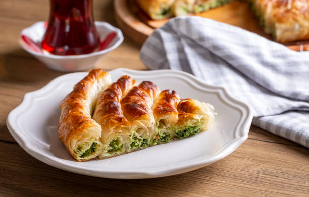 istock Traditional Turkish pastry with spinach. (Turkish Name: Ispanakli Kol Boregi, Bosnak boregi). Handmade pastry with spinach filling. 1537300265
