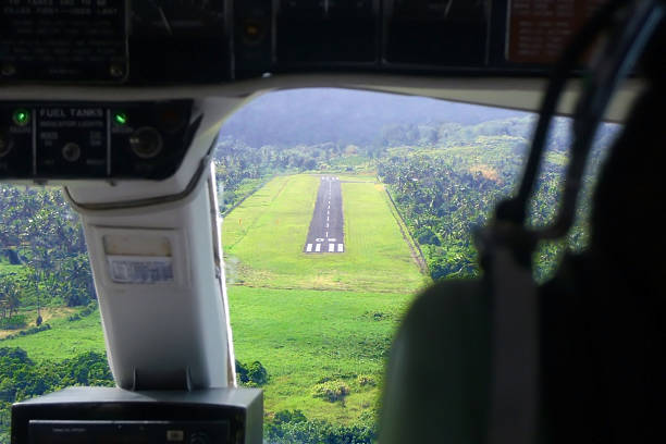 Landing cockpit view The aircraft is landing on small airstrip placed in jungle on Ovalau Island in Fiji. I was seating just behind the pilots so I could take this rare picture. suva photos stock pictures, royalty-free photos & images