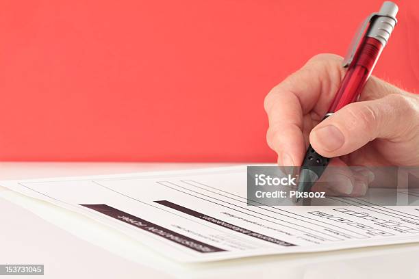Red Themed Pen In Hand Completing Form Stock Photo - Download Image Now - Application Form, Business, Close-up