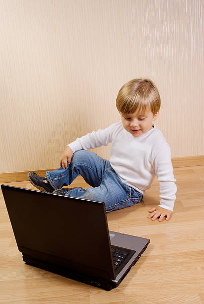 istock Child on the floor with laptop 153731053