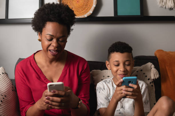 istock Mother and young son using cellphone 1537314852