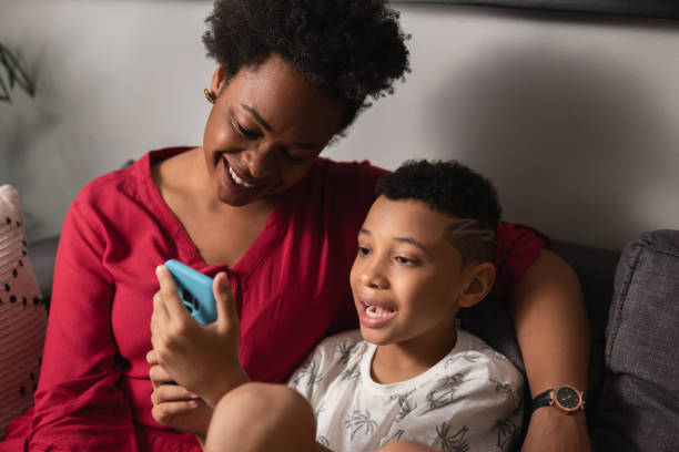 istock Son with mother looking at cell phone 1537314859
