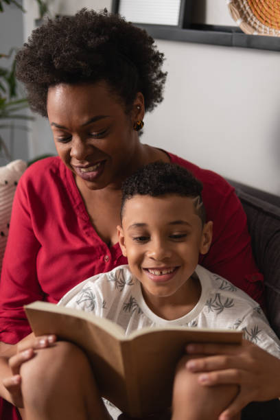 istock Mother and son reading book together 1537314872