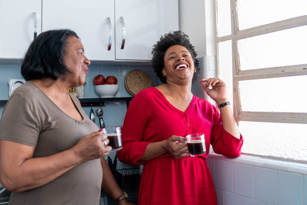 istock Daughter and elderly mother laughing at home 1537315438