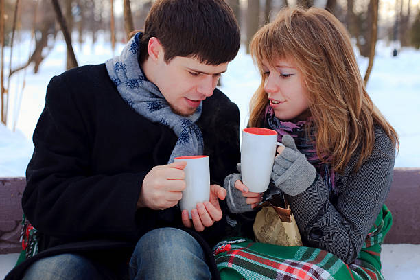 istock young beloved couple warming themselves in the winter park 153732079