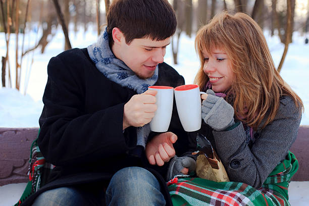 istock young beloved couple warming themselves in the winter park 153732084