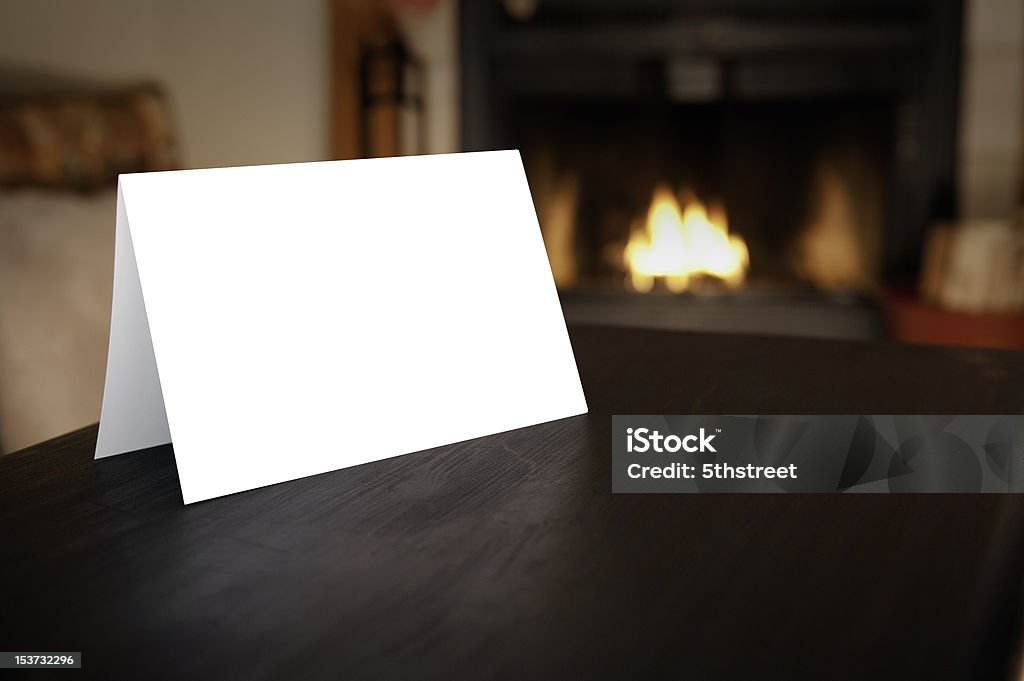 Blank Card in front of Fireplace Blank horizontal christmas card folded in front of burning fireplace Christmas Card Stock Photo