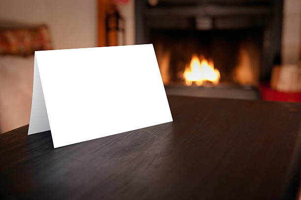 Blank Card in front of Fireplace Blank horizontal christmas card folded in front of burning fireplace blank christmas card stock pictures, royalty-free photos & images