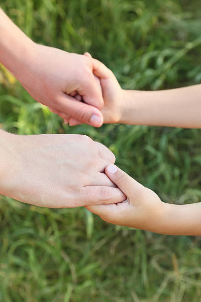 istock Mother and son hands holding each other 153733839