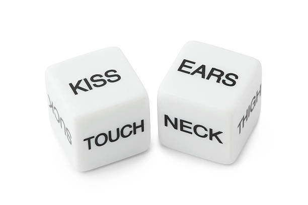 White dice with erotic messages on the sides stock photo