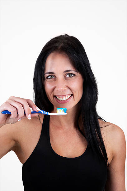 istock Smiling woman with toothpaste and toothbrush 153733886
