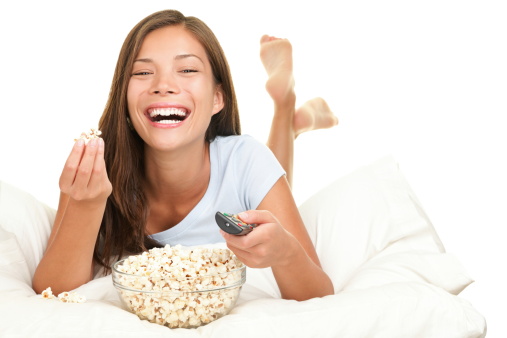Woman watching funny movie laughing. Isolated on white background. Click for more: