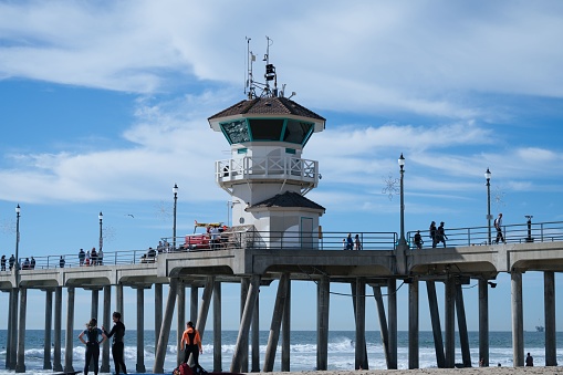 Newport, United States – November 25, 2022: The Huntington Beach Pier against the background of a cloudy sky.