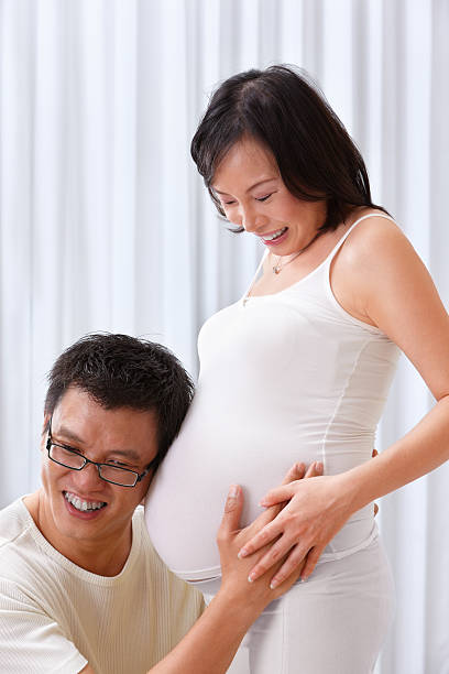istock Husband try to hear fetus sound 153736732
