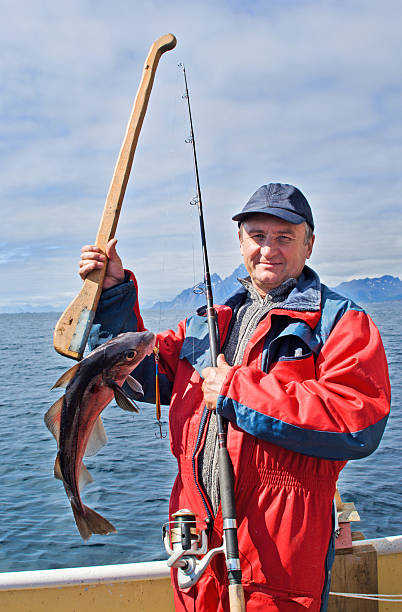 istock Fisherman with a fish on the Lofoten island 153736734