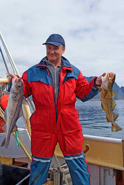 istock Fisherman with fish on the boat 153736785