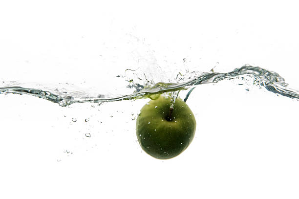 Apple splashes in rough water stock photo