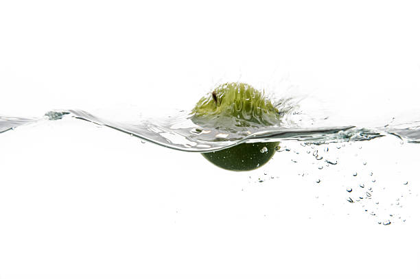 Green Apple splashes in water stock photo