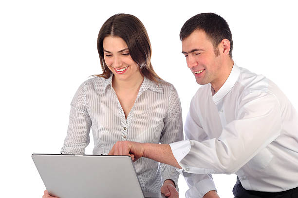 Man and woman looking at laptop stock photo