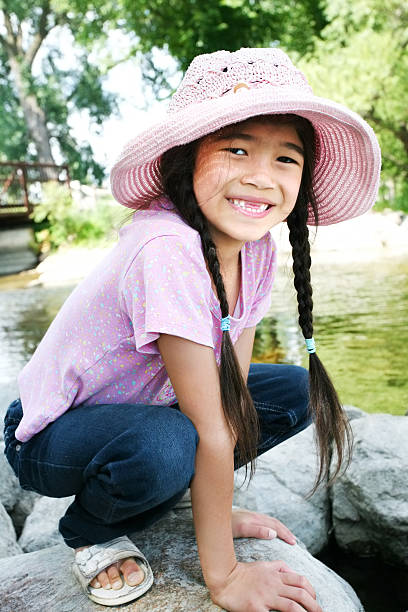 istock Little girl playing on rocks by river 153738212