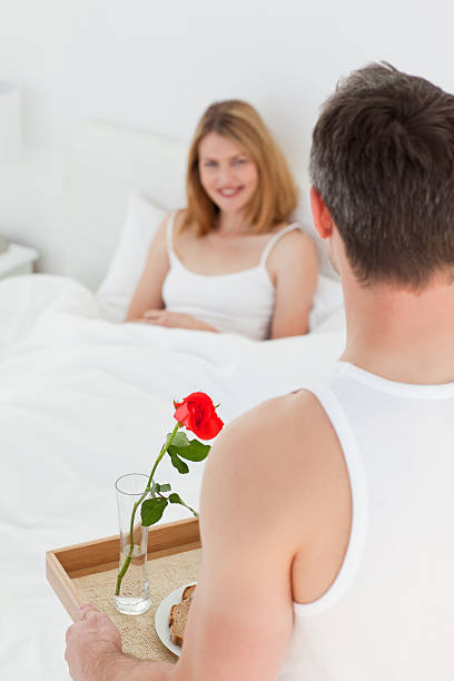 istock Joyful lovers having breakfast in their bed 153738805