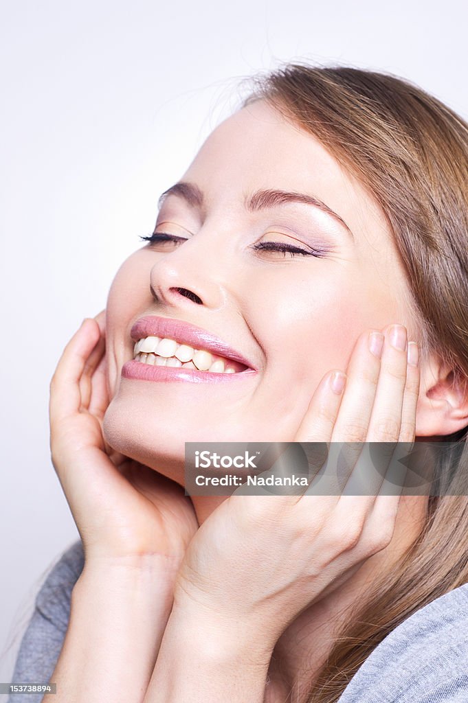 Young beautiful woman smiling Young beautiful woman smiling. White background Adult Stock Photo