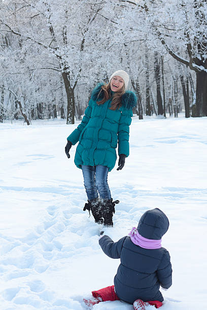 istock Mother and  kid having fun outdoors on beautiful winter day 153739470