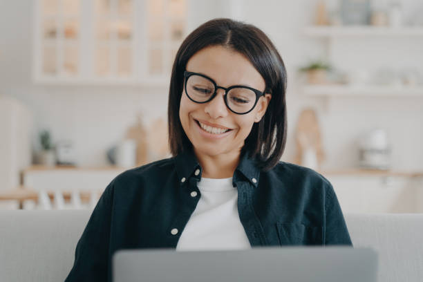 istock Smiling freelancer learns online, works from home. Young woman studies on laptop. Remote job, e-learning. 1537400531