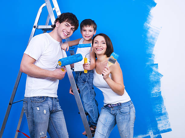 istock Happy family with paintbrush 153740103