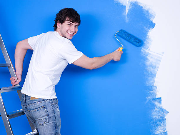 istock Happy man painting the wall 153740119