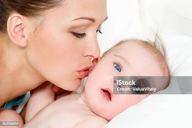 A Mother Kissing Her Newborn Baby Stock Photo - Download Image Now - Adult, Baby - Human Age, Beautiful People