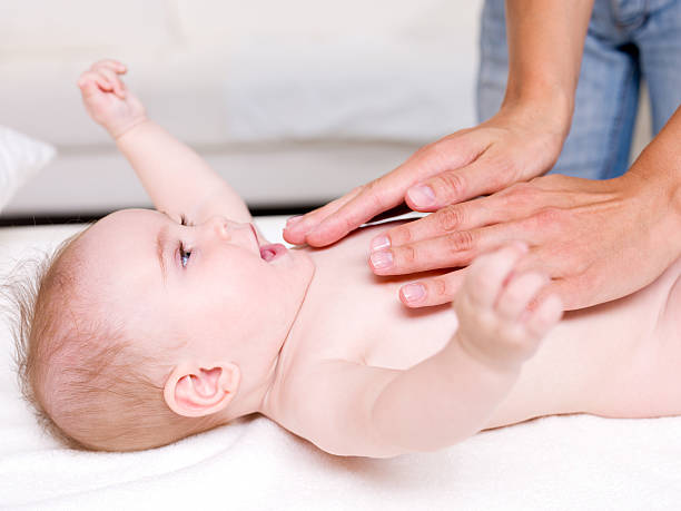 istock massaging of newborn baby 153740471