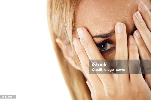 Shy Woman Looking Through Fingers Stock Photo - Download Image Now - 30-34 Years, 30-39 Years, Adult