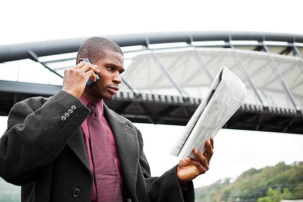 istock Businessman reading newspaper 153741498