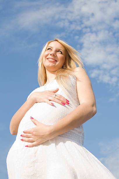 istock Expectant mother on background of sky 153741574