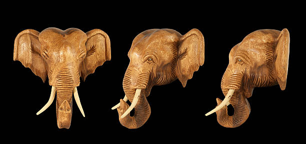 istock Sculpture (wood) picture elephant head. Isolated on pure black 153741725