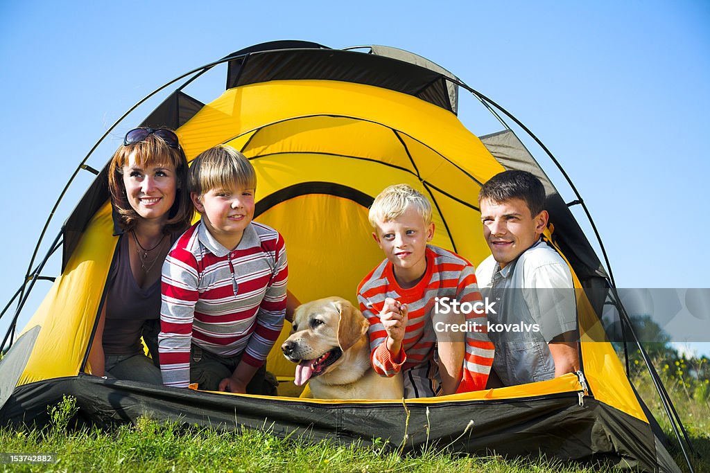 hapy family happy family in the tent on sunny meadow Active Lifestyle Stock Photo