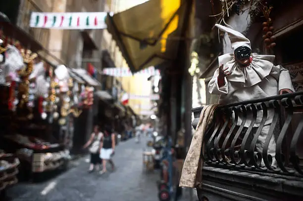 Puppets of Pulcinella, typical masquerade character, in the small streets in San Gregirio Armeno,  the centre of Napoli