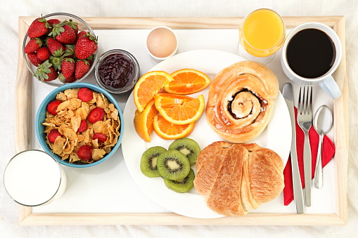 Breakfast tray in bed with coffee, bread, cereals, fruit etc. Click for more: