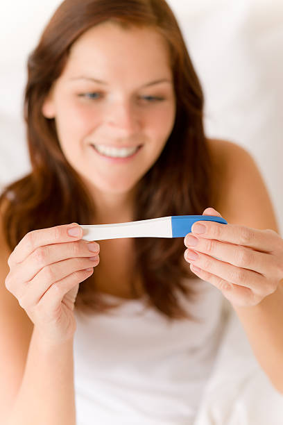 istock Pregnancy test - happy surprised woman 153744268