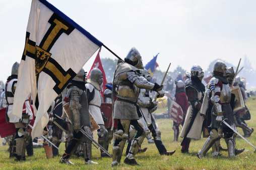 Lugo, Spain- June 11, 2022: Roman soldiers in a row , traditional festival recreation , high angle view of part of the parades of the Arde Lucus traditional festival, Roman Historical Reenactment.Metal suit of armor and helmet. Lugo city, Galicia, Spain.