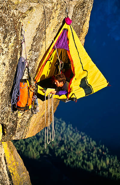 istock Rock climber bivouaced in a portaledge. 153744873